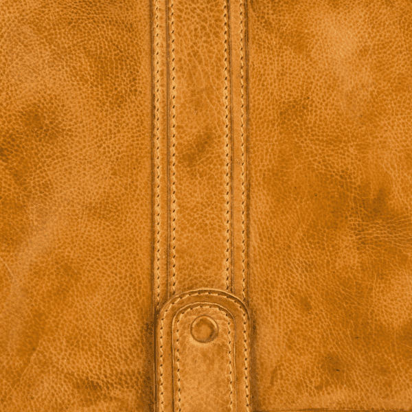 Close-up of handcrafted leather texture and stitching by leather goods manufacturer in India.