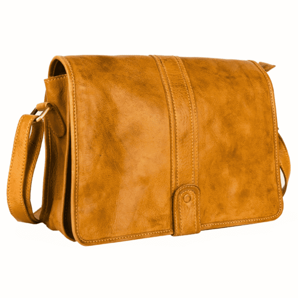 Front angled view of tan leather messenger bag with flap closure by leather goods manufacturer in India.