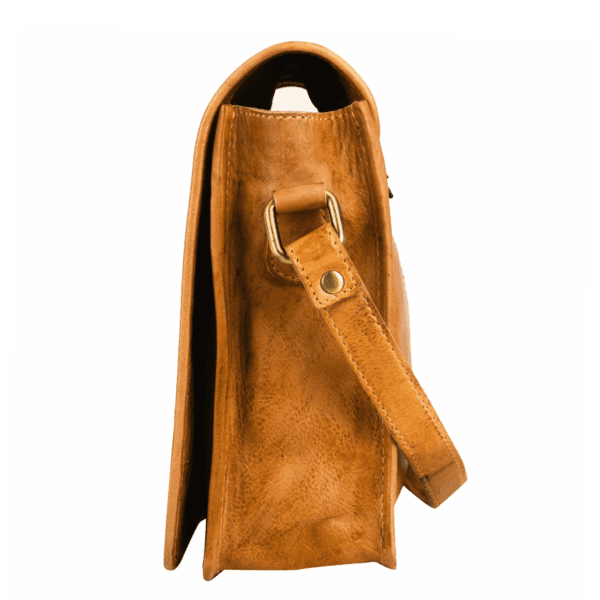 Side profile of tan leather sling bag with strap detail by leather goods manufacturer in India.