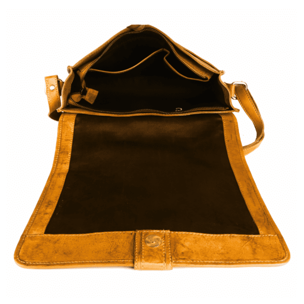 Open view of a handcrafted leather shoulder bag with multiple compartments, made by a leather goods manufacturer. Premium leather bag design showcasing inner pockets and suede-finish flap.